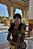 Myanmar - Mandalay, Kuthodaw Pagoda. Girl selling souvenirs wearing thanatkha   